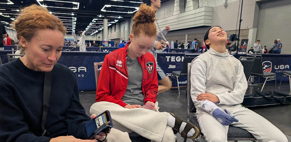 Julia resting between events with teammates